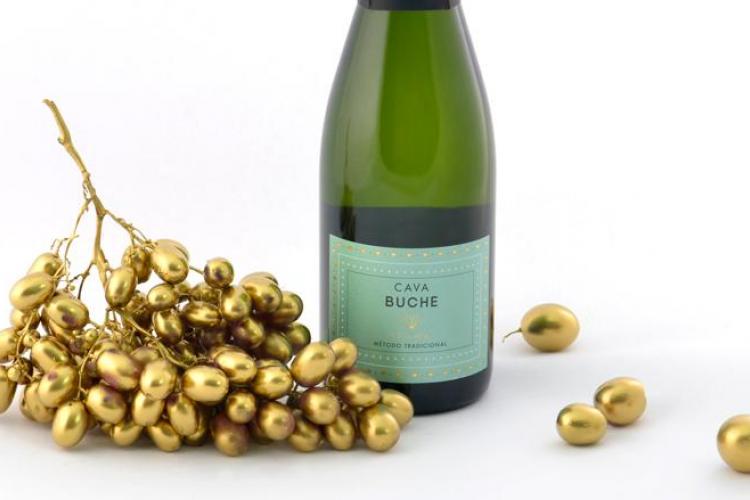Golden grapes and a bottle of Cava Buche.