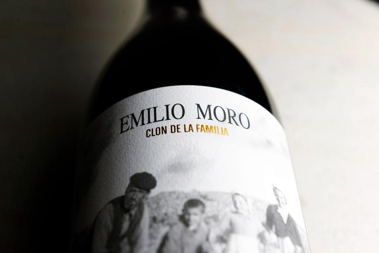 A bottle of Clon de la Familia wine laying down.